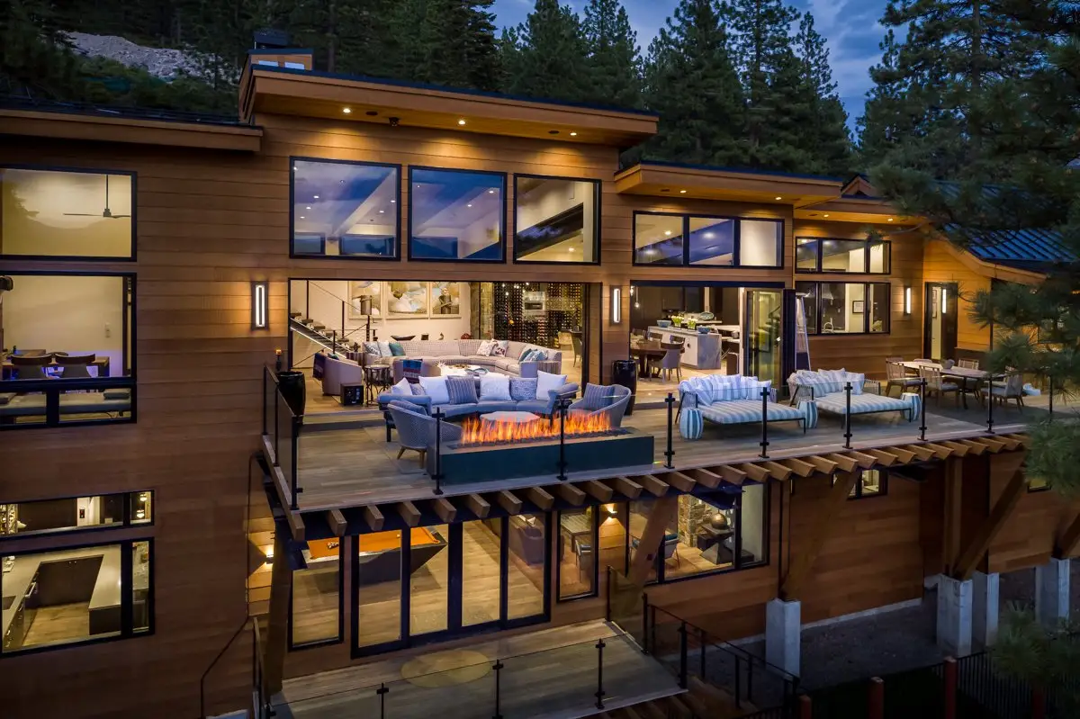Modern mountain home designed by Elise Fett & Associates, illuminated at dusk